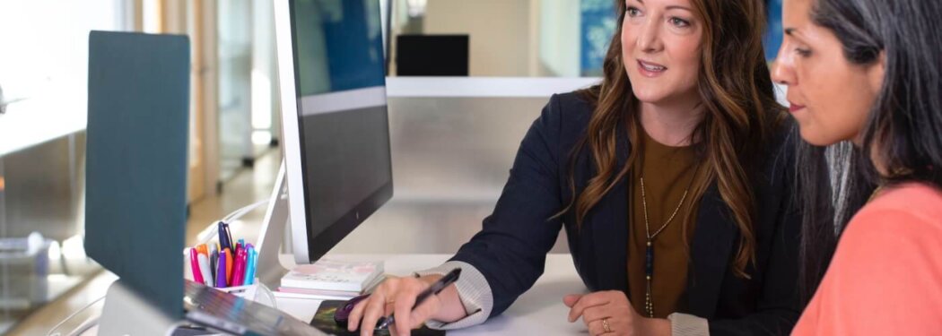 woman in black blazer sitting at the table