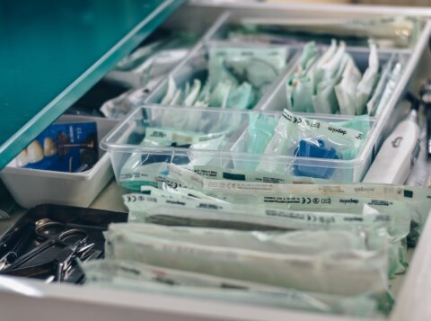 white packs with scissors and medicine on gray tray