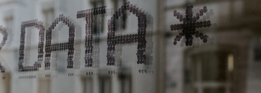 a close up of a window with a building in the background