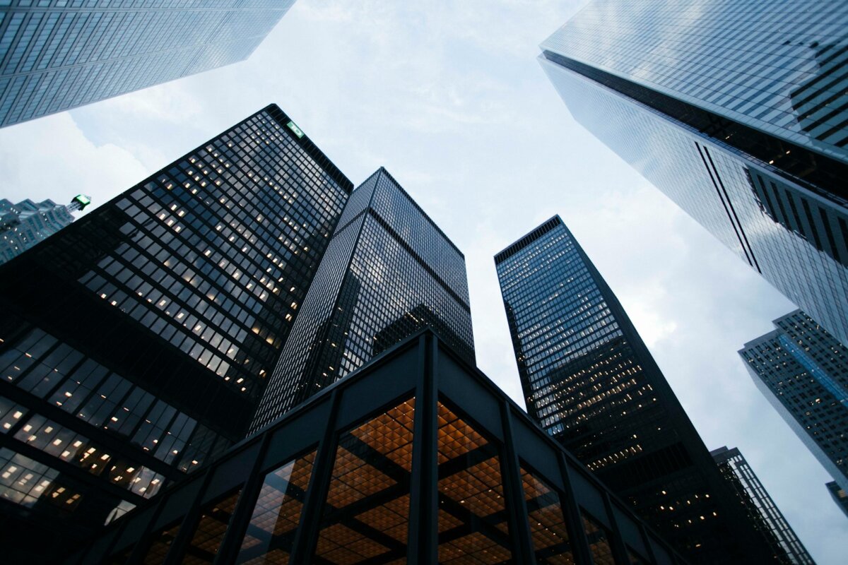 Photo by Sean Pollock - AArete low angle photo of city high rise buildings during daytime